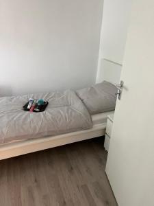 a bed in a small room with a door open at Ferienwohnung Biberach an der Riß in Biberach an der Riß