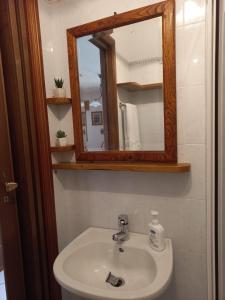 a bathroom with a sink and a mirror at La casa dei nonni in Savignano Irpino