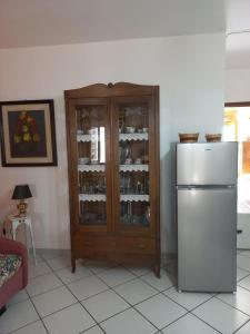 a kitchen with a refrigerator and a cabinet with wine glasses at La casa dei nonni in Savignano Irpino