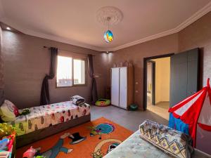 a kids room with two beds and a refrigerator at Room 3 villa Sunset Moulay Bouzerktoun in Essaouira +48 photos