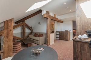 a living room with a table and a couch at La Maison des Ducs in Chambéry