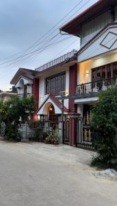 a building with a gate in front of it at House of Raj in Madikeri
