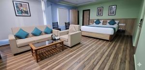 a hotel room with a bed and a couch at Hotel SVA in Visakhapatnam +48 photos