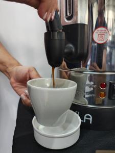 a person is mixing a bowl in a mixer at Ibis Puerto General San Martin in Aldao +14 photos