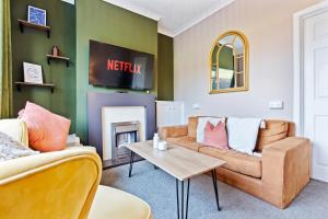 a living room with a couch and a fireplace at Haven on the Hill - FREE Parking & Great for Groups in Abertillery