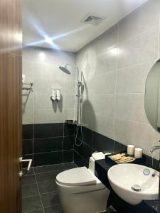 a bathroom with a toilet and a sink at Elegant Hotel in Hanoi