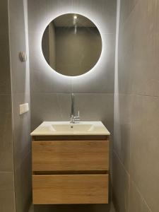 a bathroom with a sink and a mirror at Nieuw Studio 16 met uitzicht op Domburg in Aagtekerke