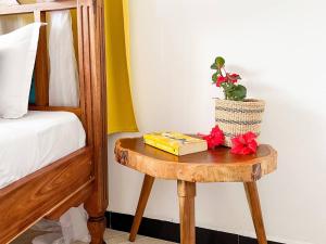 a table with a book on it next to a bed at Outdoor Cinema Group Friendly Retreat in Pingwe +72 photos