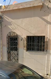 two windows on the side of a building with bars at Casa de vó in Belém