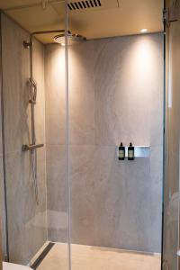 菲尔德施塔特Das Kaya Hotel Stuttgart Airport Messe的浴室里有玻璃门的淋浴间