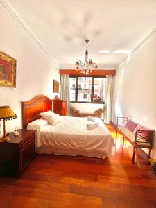 Un dormitorio con una cama y una lámpara de araña. en LaSuiza, en Bilbao