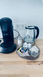a black coffee maker sitting on a wooden table at Baadenberger stay 1 in Cologne