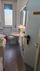 a bathroom with a sink and a toilet at Novegro Linate 101 in Linate +6 photos
