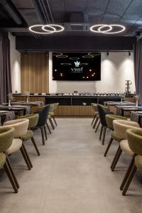 a dining room with tables and chairs and a stage at Silver Apart in Truskavets