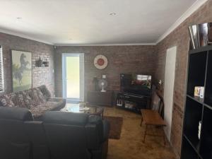 a living room with a couch and a table at Classic Air B&B in Pearly Beach