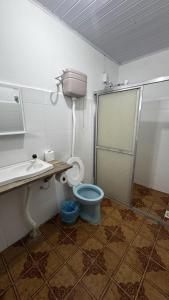 a bathroom with a toilet and a sink at Beira Mar Residencial in Capão da Canoa