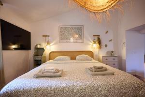 a bedroom with a bed with two towels on it at La Recampado in Bormes-les-Mimosas