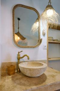 a bathroom with a sink and a mirror at La Recampado in Bormes-les-Mimosas +43 photos