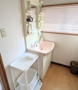 a bathroom with a sink and a mirror at Minpaku ROADHOUSE - Vacation STAY 20160v in Nagasaki