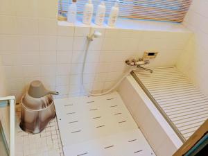 a small bathroom with a shower with a toilet at Minpaku ROADHOUSE - Vacation STAY 20160v in Nagasaki +14 photos