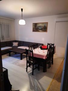 a living room with a table and chairs and a couch at Appartment in the center of town Fushe Kosova in Kosovo in Kosovo Polje