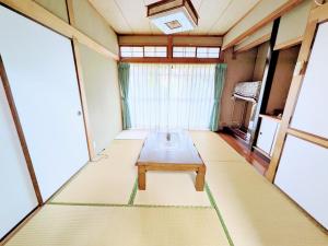a room with a table in the middle of a room at Minpaku ROADHOUSE - Vacation STAY 20160v in Nagasaki