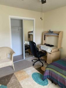a bedroom with a desk and a chair and a mirror at 4182 Thistle cir in Virginia Beach
