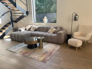 a living room with a couch and a table and a chair at Home Terboekt in Genk