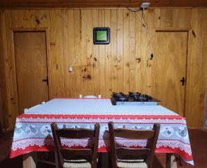 a dining room with a table and a stove at Casa Pessegueiro in Urubici +16 photos