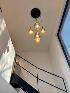 a glass staircase with a chandelier in a house at Home Terboekt in Genk