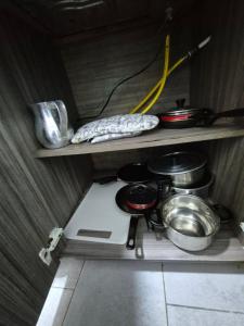 a kitchen with a stove and some pots and pans at Apartamento centro de pereira a 2 cuadras del hospital san jorge in Pereira +12 photos