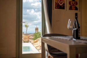 a door to a balcony with a view of the ocean at Loft con terrazzo sulla Scala in Caltagirone +17 photos