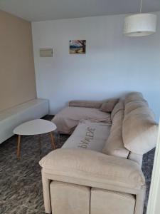 a living room with a couch and a table at Sea and Sun con vistas a la playa San Antoni in Cullera