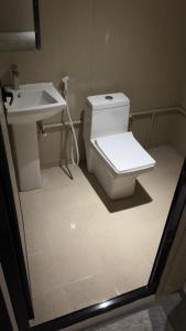 a bathroom with a toilet and a sink at Aurora desert camp in Bidiyah +26 photos