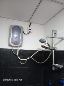 a hair dryer on the wall of a bathroom at Ella Cool Air Cabana in Ella