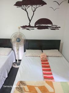 a bed with a red and white striped tie on it at Ella Cool Air Cabana in Ella +27 photos