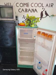 a refrigerator with its door open with food inside at Ella Cool Air Cabana in Ella