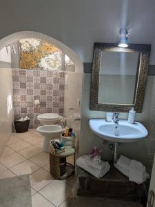 a bathroom with a sink and a toilet and a mirror at Il Geco in Matera +147 photos