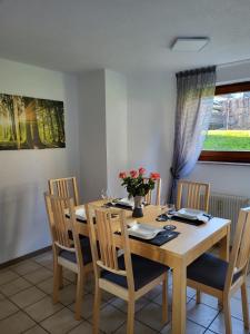 a dining room with a wooden table and chairs at Apartment HESS in Rust