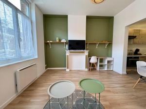 a living room with two chairs and a table at Charmant Studio - Centre Douai - Netflix - 2 pers in Douai