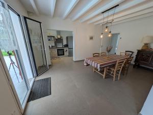 a kitchen and dining room with a table and chairs at Landaise in Messanges