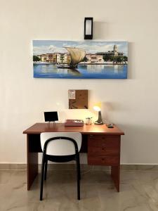 a desk with a chair and a painting on the wall at Menai Bay Escape in Mkunguni