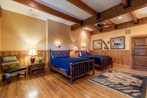 a bedroom with two beds in a room with wooden walls at Amitola at Yonahlossee in Boone +92 photos