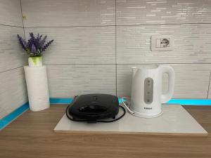 a white appliance sitting on a counter next to a blender at Beach apartment Durres in Golem