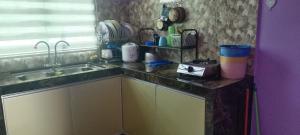 a kitchen with a sink and a counter top at Homestay kak bee d' bendang in Jitra +8 photos