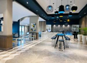 a lobby with tables and stools in a restaurant at Aryan Home Stay Lucknow in Lucknow