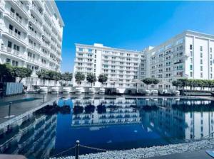 a large swimming pool in front of a large building at Aryan Home Stay Lucknow in Lucknow