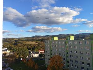 a view of a building with mountains in the background at 3-izbový byt in Prievidza +2 photos
