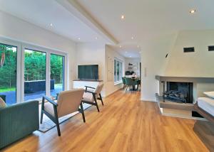 a living room with a couch and a fireplace at Ferienhaus Waldblick mit Whirlpool und Sauna in Hellwege