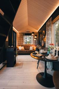 a living room with a table and a couch at Piilotupa in Inari +11 photos